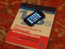 A clinical treatment planning book with an iPod Touch on top